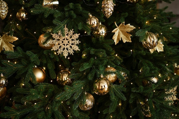 Closeup of christmas tree with toys as background concept of new year card soft focus