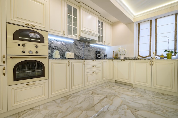 Closeup of classic creamcolored kitchen with oven microwave and other appliances