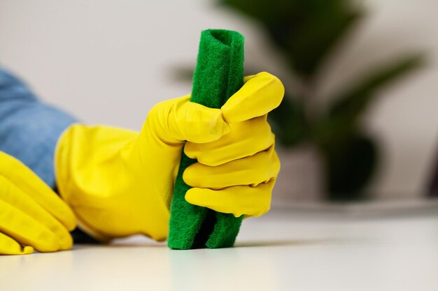 Closeup of cleaning company worker cleans office.