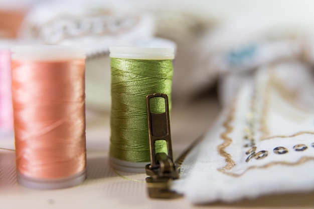 Closeup closeup threads behind dressmaker atelier seamstress sewing clothes embroidering