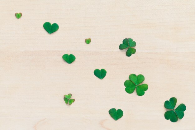 Closeup clovers leaves  setup on wooden background.