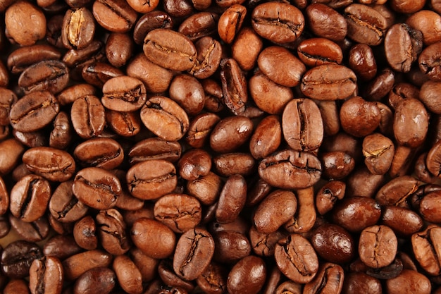 Closeup of coffee beans scattered Background