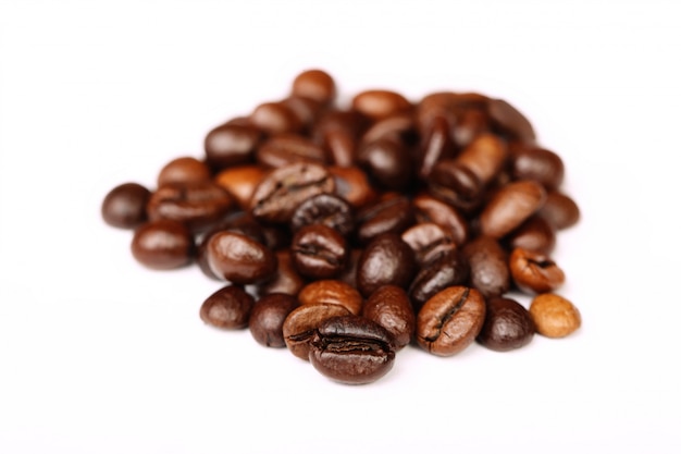 Closeup of coffee beans with focus on one