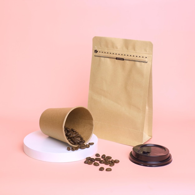 Closeup of coffee set packaging Take away cup and pouch standing with zip lock isolated on pink ba