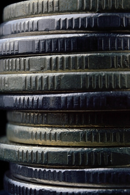 Photo closeup of coins stack isolated on black background