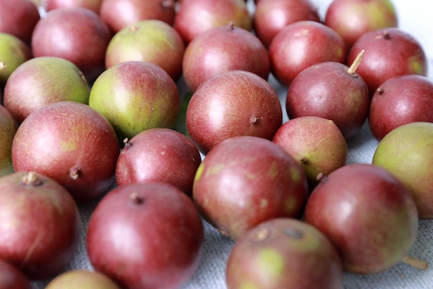 Closeup of a collection of red camu camu fruits