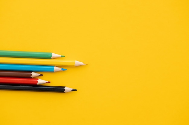 Closeup color pencil on yellow background back to school concept