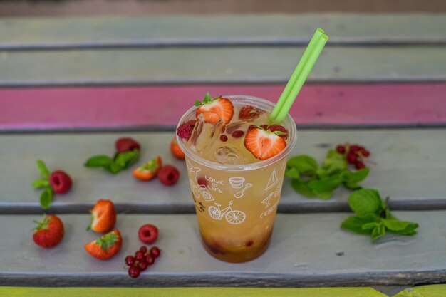 Closeup of colored cold lemonade with fresh fruits