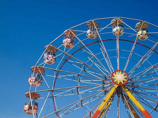 Closeup of a colorful Ferris wheel in the amusemen