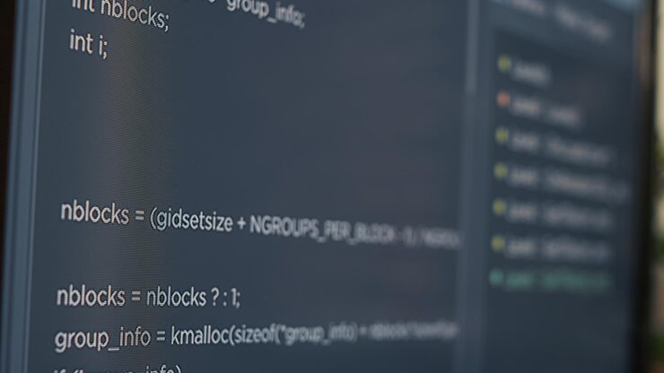 Photo closeup of computer screen of system engineer typing source code in it startup agency. display concept of software developer writing programming language. scrolling text of database functions script.