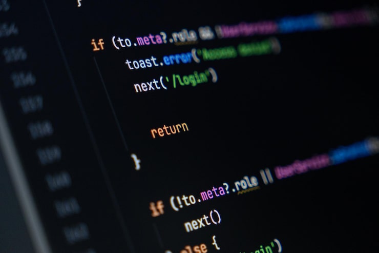 Photo closeup of computer screen with colorful programming code lines focus on return keyword software development and coding