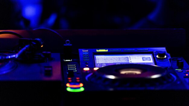 Photo closeup of a console with colored lights in the background