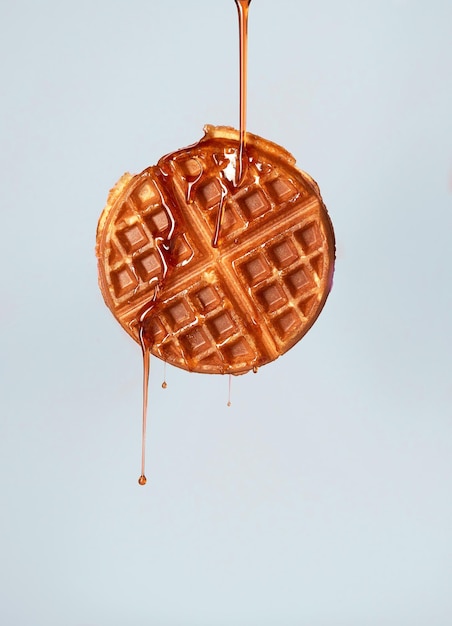 Closeup of a cookie with a caramel flowing on it from the top