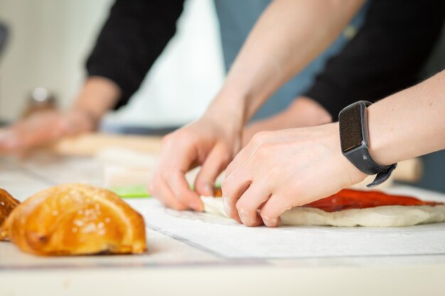 Photo closeup on cooks hands cooking bakery in a bright kitchen by two chefs selective soft focus