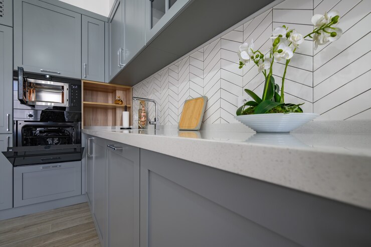 Closeup to corner of grey and white modern kitchen furniture