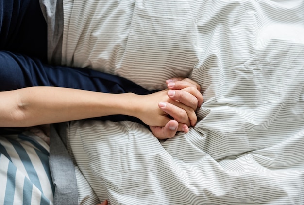 Closeup of couple holding hands