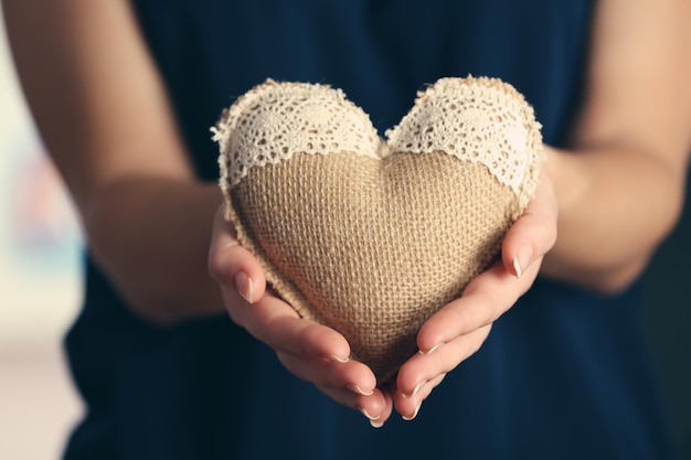 Closeup of craft heart in female hands