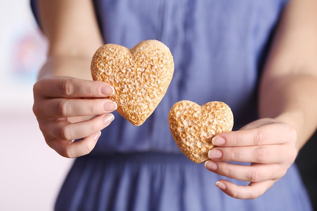 Photo closeup of craft hearts in female hands