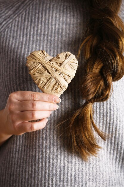 Photo closeup of craft hearts in female hands