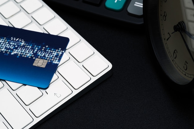 closeup credit card on black enter button, convenience shopping concept