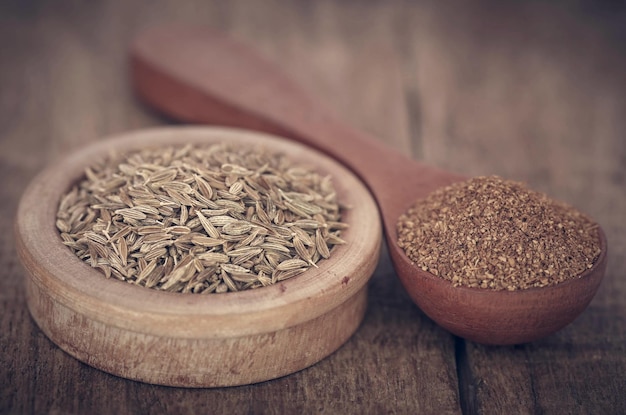 Closeup of crushed cumin with whole ones