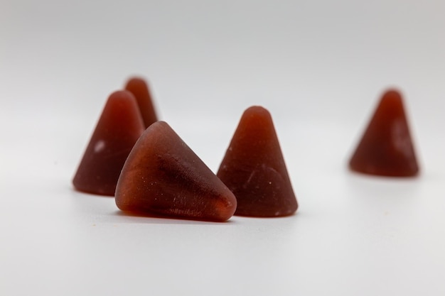 Closeup of cuberdon a coneshaped Belgian candy on a white background