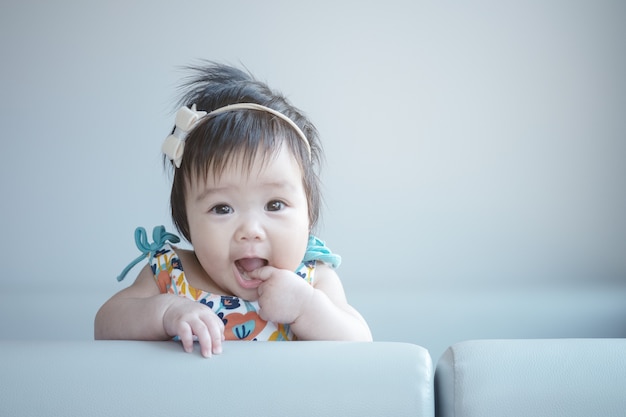 Closeup cute baby girl in funny motion with copy space