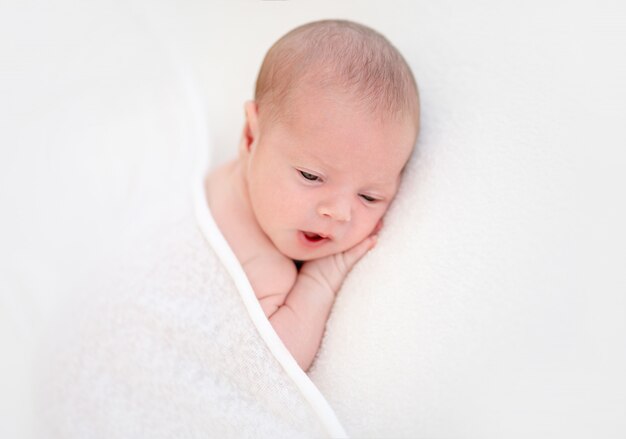 Closeup of cute newborn with eyes opened