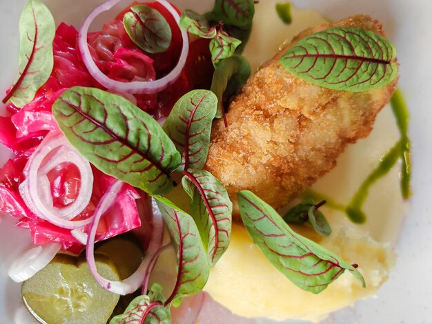 Closeup of cutlet with mashed potatoes and vegetables