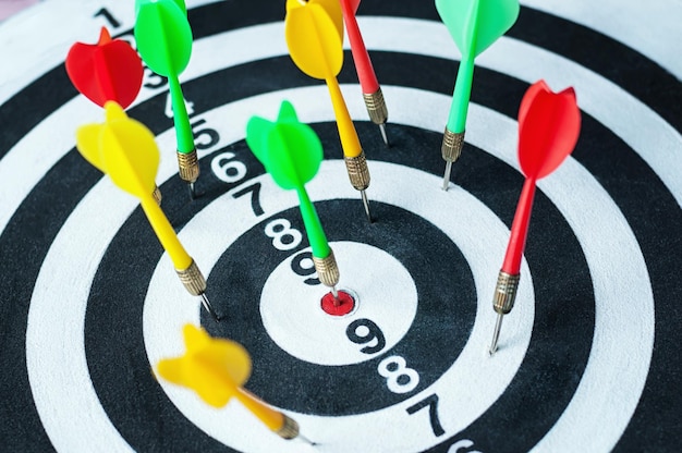 Closeup of dart board with arrows, selective focus.