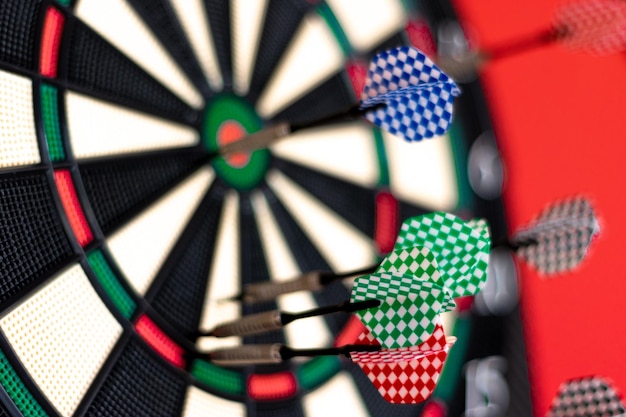 Closeup of darts stuck in a dartboard selective focus