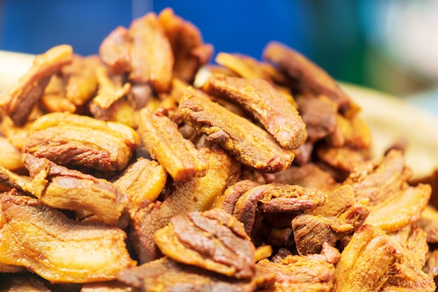 Closeup of Deep fried Pork Belly with Fish Sauce and Herb, thai street food market