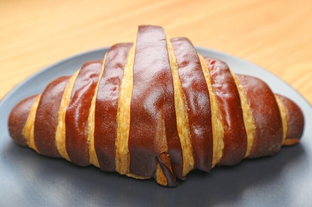 Closeup of a Delectable Bicolored Chocolate Croissant Served on Wooden Table