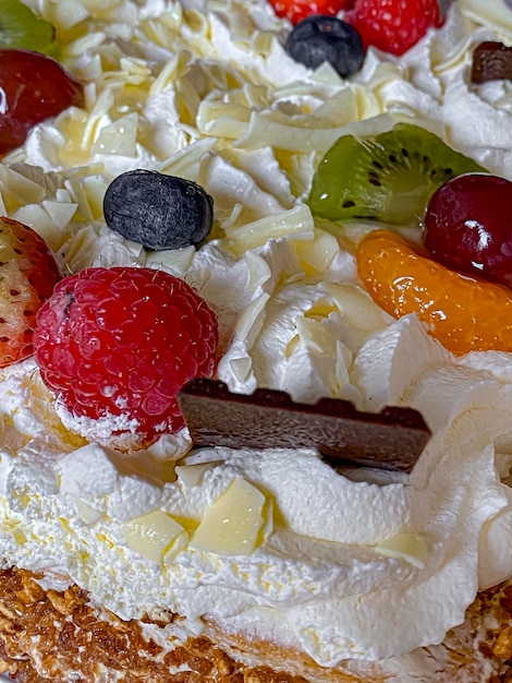 Closeup of a delicious cake with whipped cream and fruits