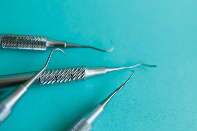 Closeup of dental scalers on blue background