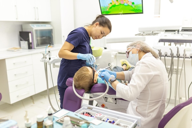 closeup dentist procedure of kids teeth a child boy with a dentist in a dental office