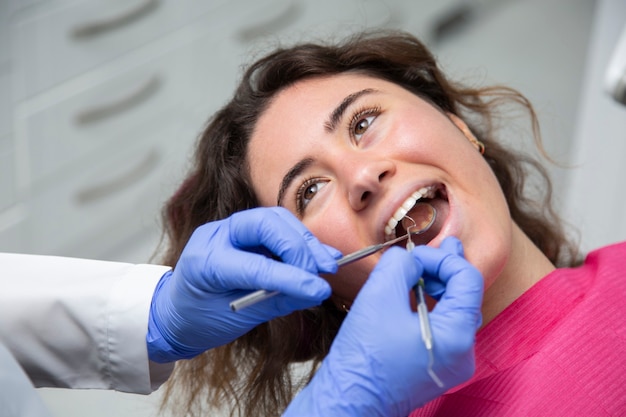 Closeup of dentist working on a girl's mouth.