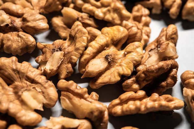 Closeup detail of already peeled walnut on a white table for a diet