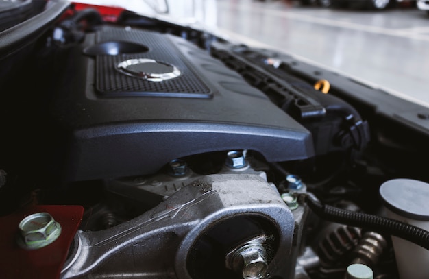 Closeup detail of car engine with soft-focus in the background. over light