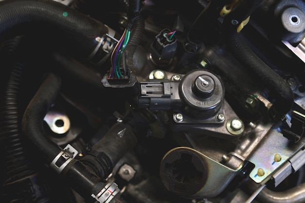 Closeup detail of car engine with soft-focus and over light in the background