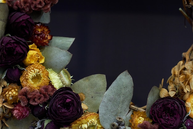 Closeup detail of a vintage wreath of dried flowers in pastel colors, selective focus