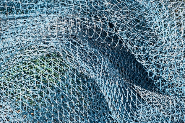 Closeup detailed view of nets buoys and other objects used in industrial fishing from a boat stacked in a fishing port