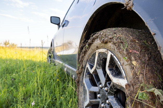 Closeup of dirty off-road car wheels with dirty tires