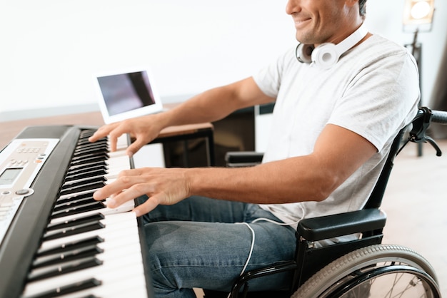 Closeup of Disabled Male Hands Plays Synthesizer.