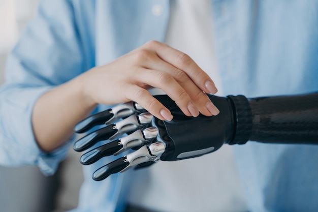 Closeup disabled woman turns on her bionic prosthetic arm Advertising of high tech prosthesis