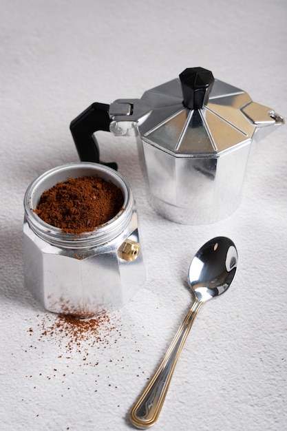 Closeup of a disassembled geyser coffee maker with poured natural coffee