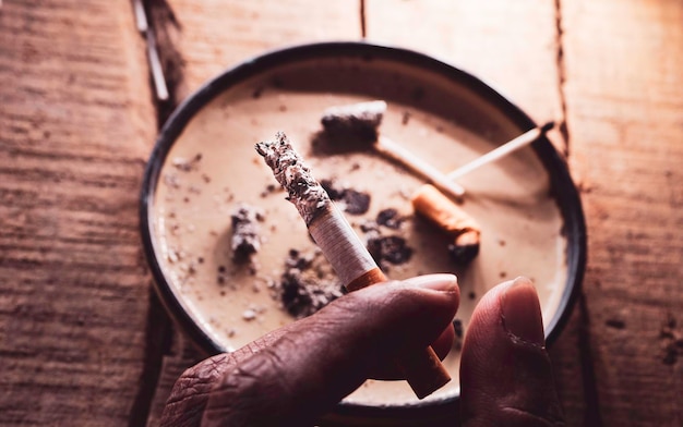 Photo closeup of discarded cigarette butts with ash