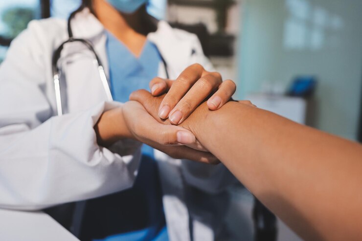 Photo closeup doctor holding hands with senior woman and cancer care or support healthcare or trust empathy or compassion and female caregiver or nurse holding elderly person hand for hope and kindness