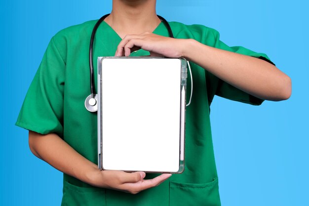 closeup of doctor or nurse holding digital tablet with blank white screen for ad mockup