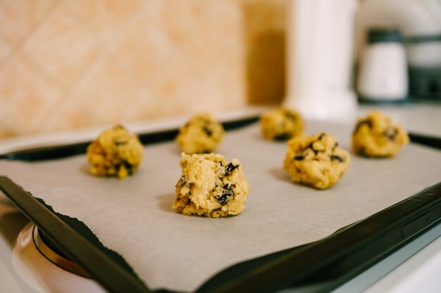 Closeup of the dough balls of raw american cookies on the counter